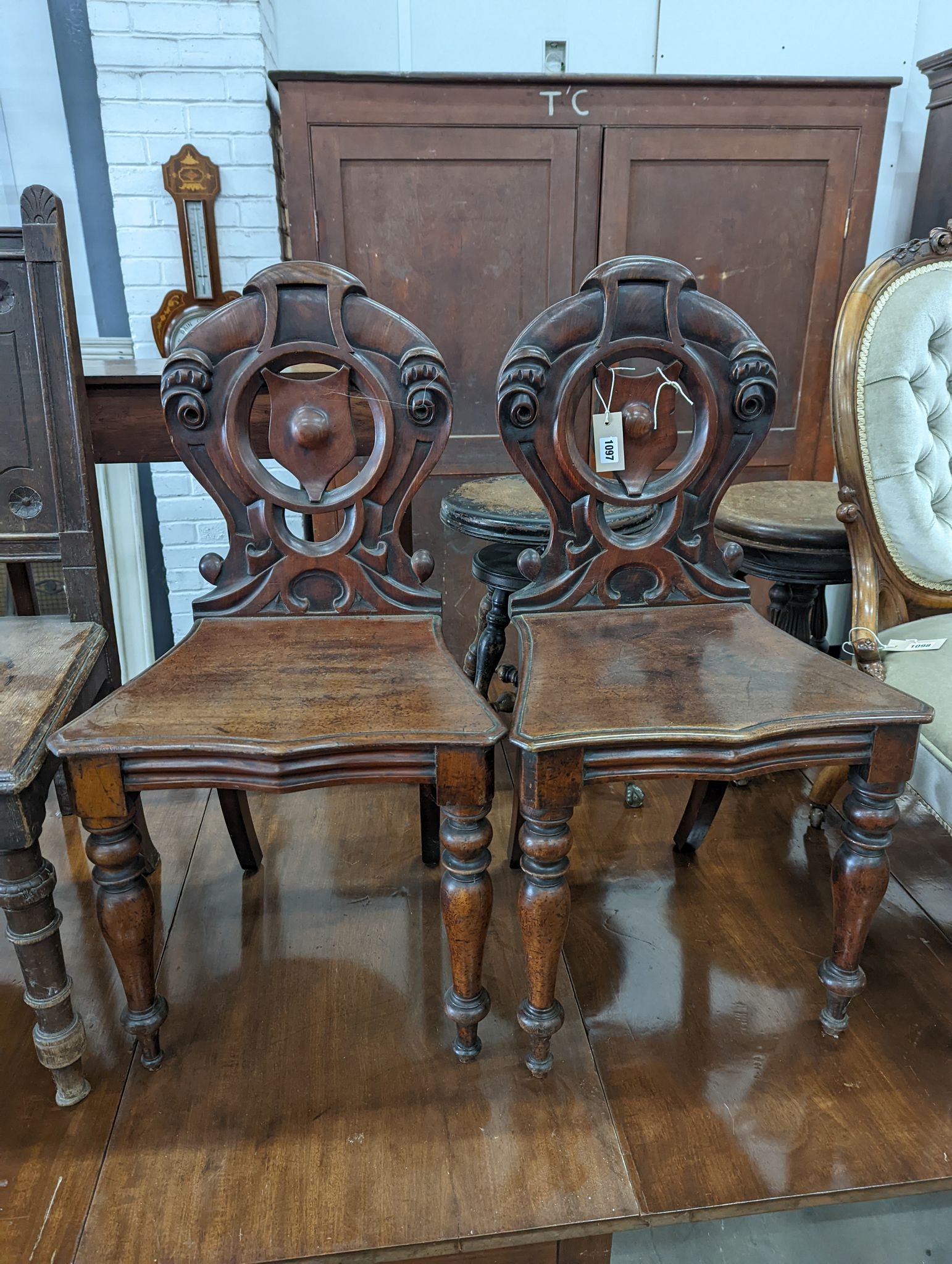A pair of Victorian mahogany hall chairs and an oak hall chair